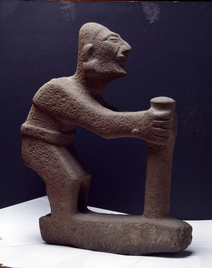 Escultura de un personaje encorvado con bastón